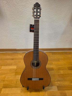 a guitar that is sitting on a stand on the floor