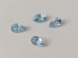trois pierres précieuses de topaze bleue sur un fond blanc