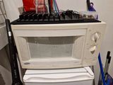 a white microwave oven sitting on top of a white stove