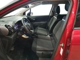the interior of a red car with the door open and the driver ' s seat down