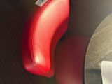 a red chair that is next to a table