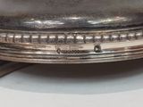 a close up of a silver plate on a table