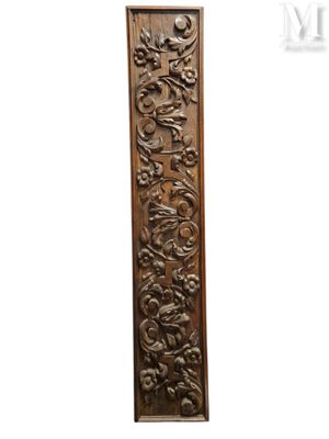 a wooden panel with a design of flowers and leaves on it