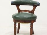 an image of a green chair with a wooden frame and leather upholstered seat