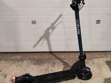an electric scooter parked in front of a garage door