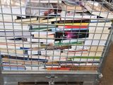a metal cart full of books sitting on the floor