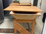 a wooden table with a bowl on it in a kitchen