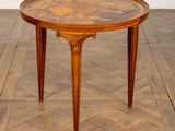 an image of a round table with a wooden top on a parquet floor