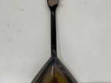 a spoon with a picture of a man on it hanging on a wall