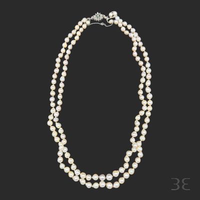 a three strand pearl necklace with a diamond clasp