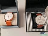 two watches that are in a box on the table