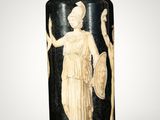 an antique black and white vase with a woman holding a shield