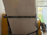 a white refrigerator sitting in a room with a yellow door