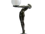 statue of a woman holding a glass ball on a tray