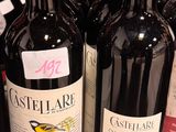 several bottles of wine are lined up on a shelf in a store