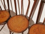 three wooden chairs sitting next to each other on top of a hard wood floor