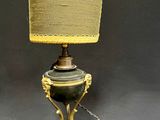 a lamp that is sitting on a table with a lamp shade on it