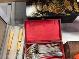 many different types of silverware in a box
