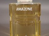 an image of a bottle of perfume sitting on top of a table