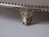 a silver plate with a decorative design on it