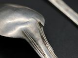 a spoon and a spoon rest on a black surface