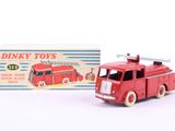 a red toy fire truck with a box in the background
