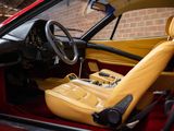 a red sports car with yellow leather seats and a steering wheel