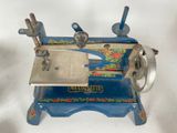an old sewing machine with a blue base and a blue handle