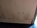 a close up of a wooden box with a name on it