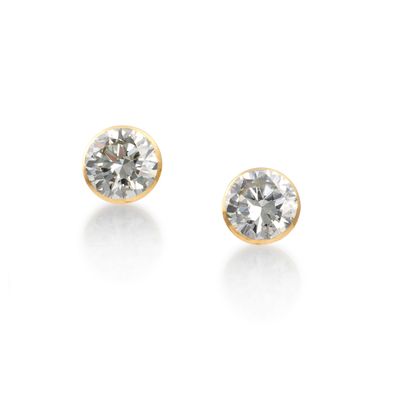 a pair of diamond stud earrings on a white background