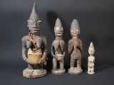 three wooden figurines of different shapes and sizes on a black background