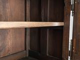 a wooden cabinet with a door open on the inside of it