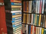 a lot of books stacked on a shelf in a room