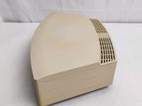an old computer sitting on top of a white table