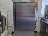 a stainless steel refrigerator in a kitchen with a lot of counter space