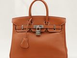 un sac à main en cuir marron muni d'un cadenas sur la poignée