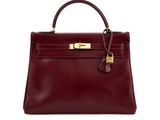 a burgundy leather handbag with gold hardware