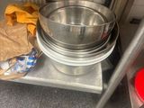 a metal shelf with bowls and other items on it