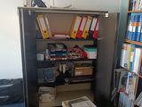 a bookcase with many books on it in a room