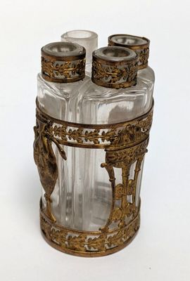 a glass jar with a lid that has a bird on it