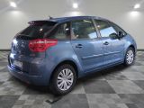 a picture of a blue car parked in a garage