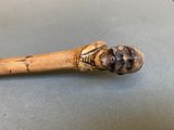 a wooden stick with a face on it on a table