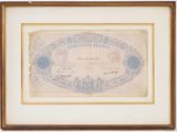 un ancien billet de banque sur lequel figure, en arrière-plan, l'image d'une ville
