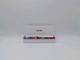 an image of a small white box with a rainbow stripe on it