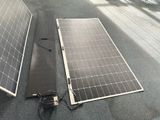 two solar panels laying on the ground next to each other