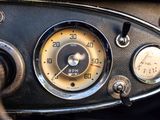 a close up of a car dashboard with a speedometer and gauges