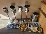 a lot of utensils and spoons sitting on a table