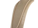 a close up of a mannequin with pearls on a white background