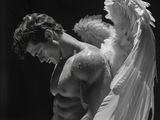black and white photograph of a man with angel wings on his back