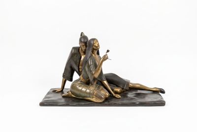 statue of a woman sitting on a rock with a cigarette in her hand
